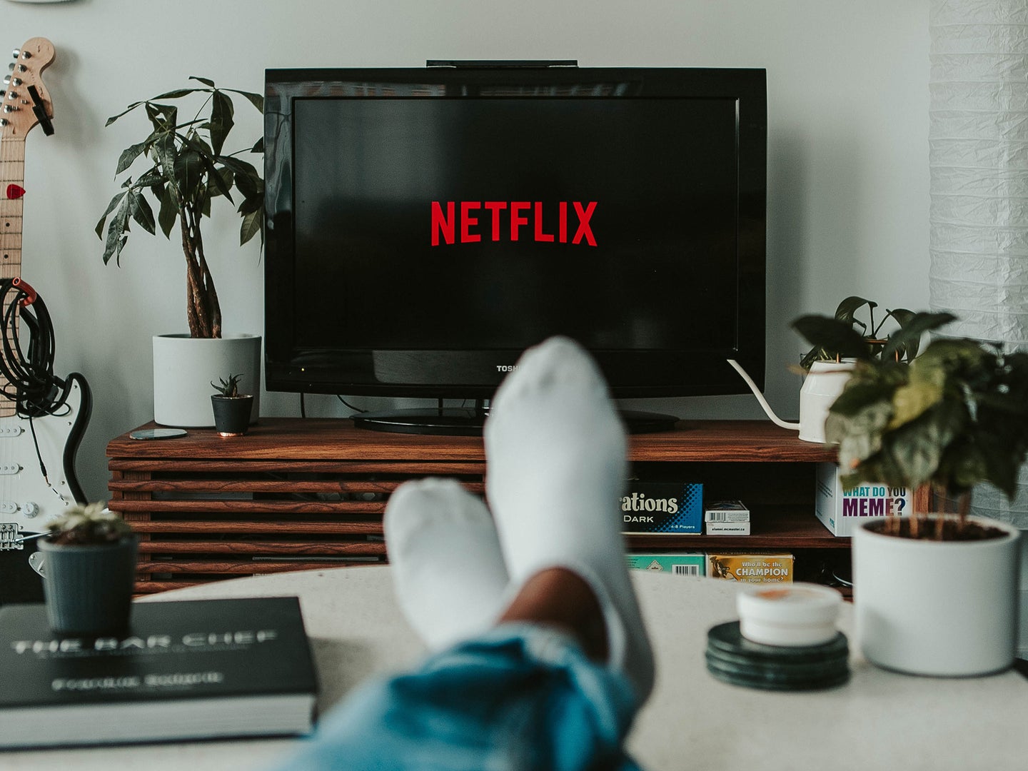 Person with their feet up watching Netflix in a big screen TV.