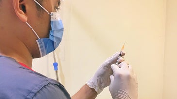 person preparing a vaccine
