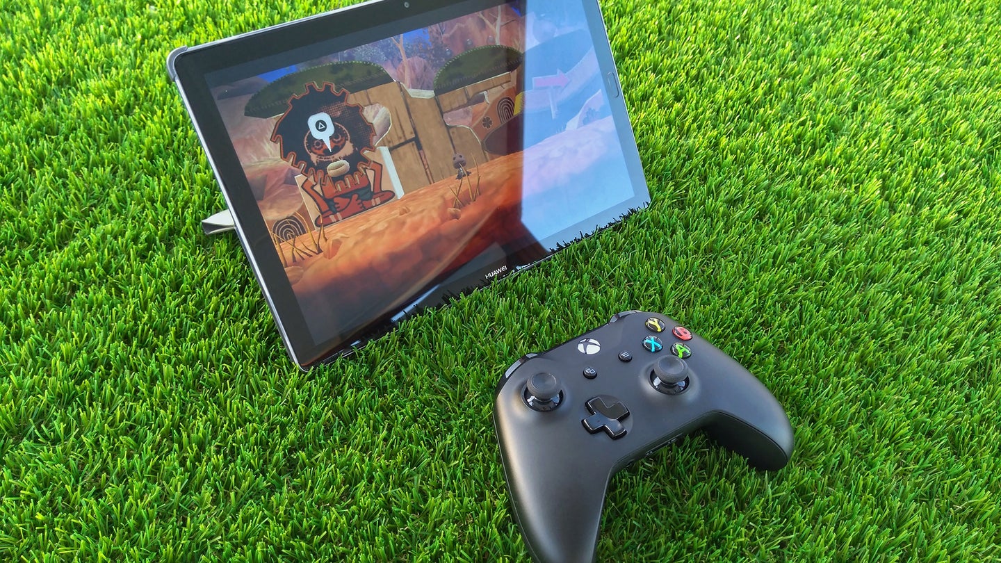 Samsung tablet on green grass with an xbox controller next to it