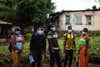 aid workers in Africa go door-to-door to deliver accurate information about Covid-19