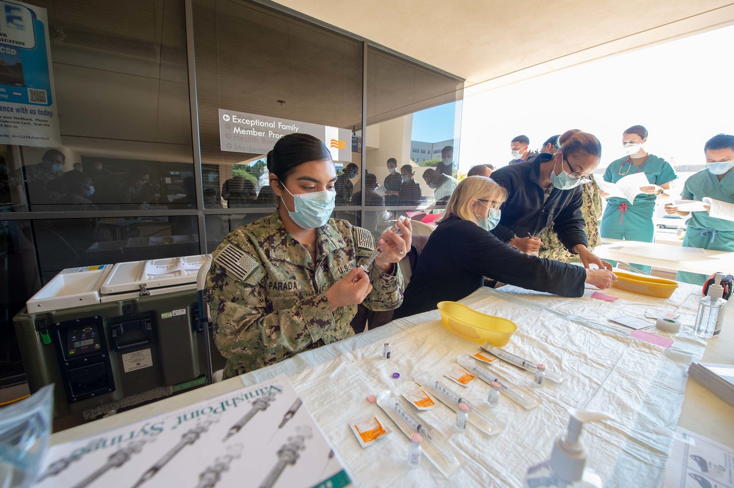 A US sailor at the Naval Medical Center in San Diego, California, prepares Pfizer COVID-19 vaccines for rollout