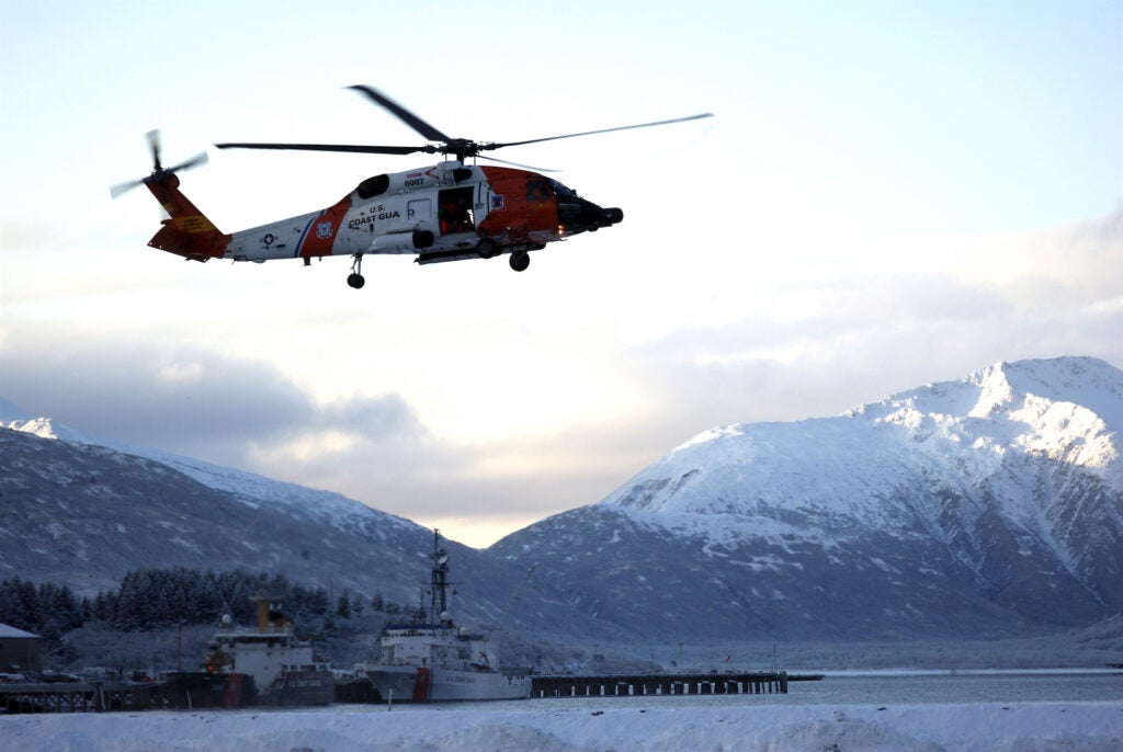 A Coast Guard MH-60 Jayhawk helicopter hovering.