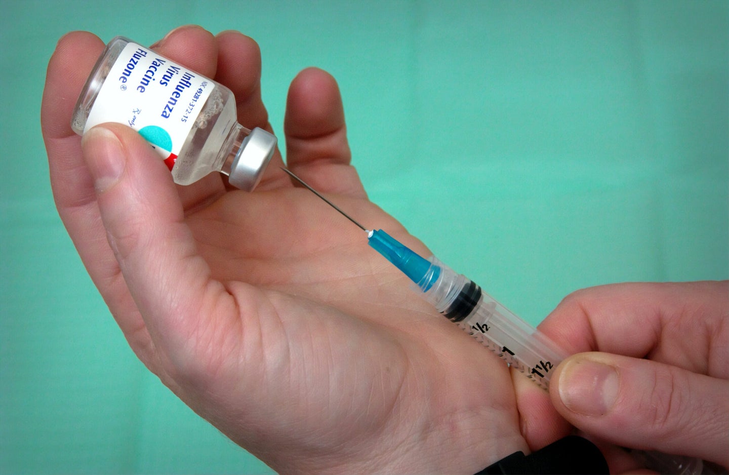 Close up of influenza vaccine shot being prepared.