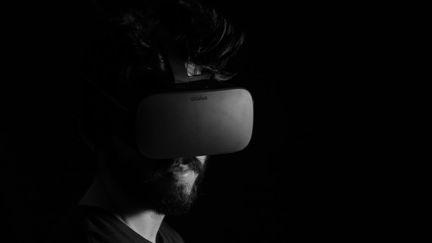black and white photo of a man with oculus vr headset on