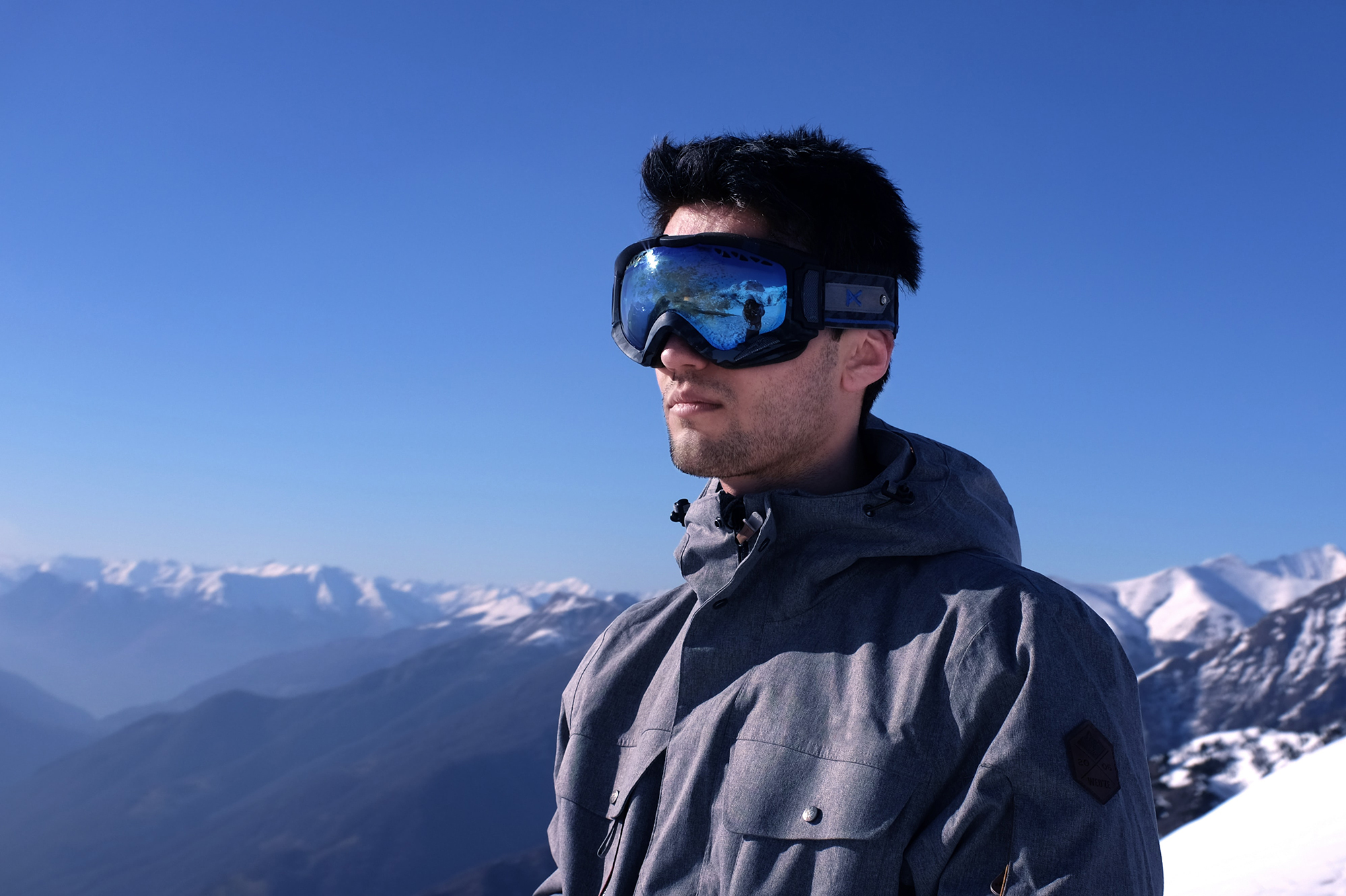 man wearing ski goggles on a mountain