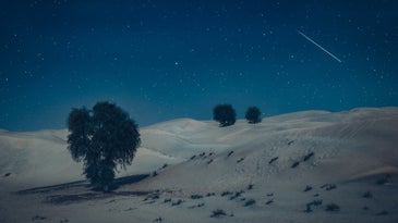 A shooting star in a night scene over the Arabian Desert