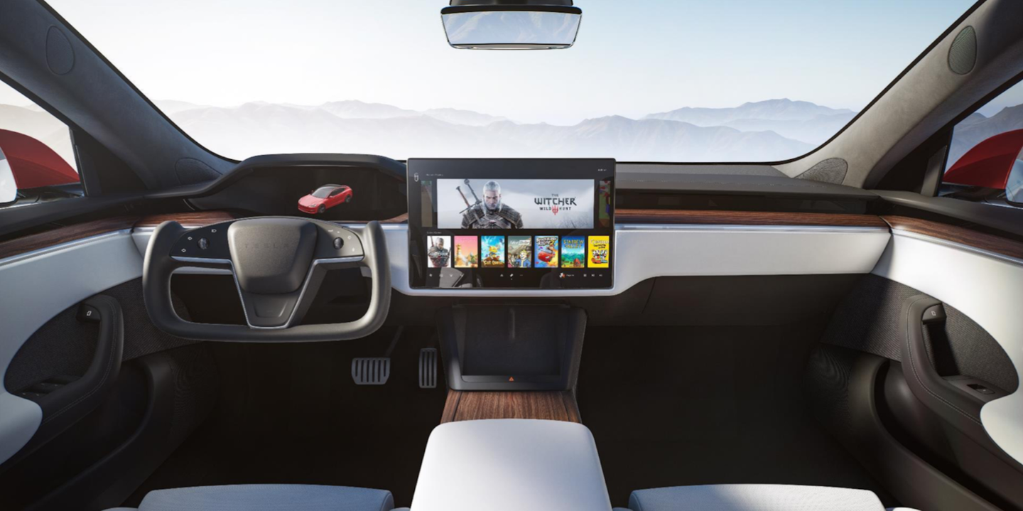 An interior view of the new Tesla Model S, including a yoke-like steering wheel and big center screen.