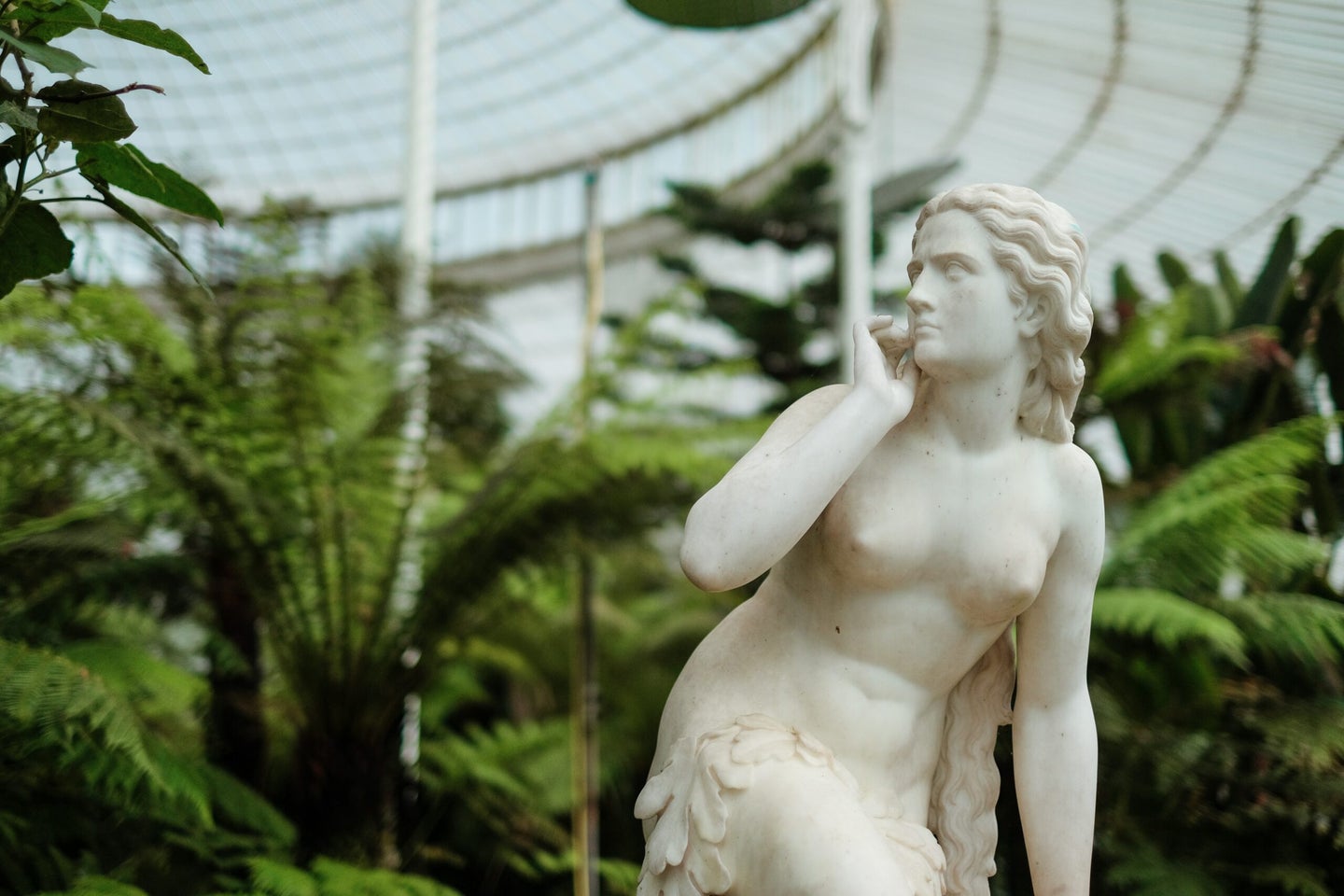 Naked woman statue in garden.