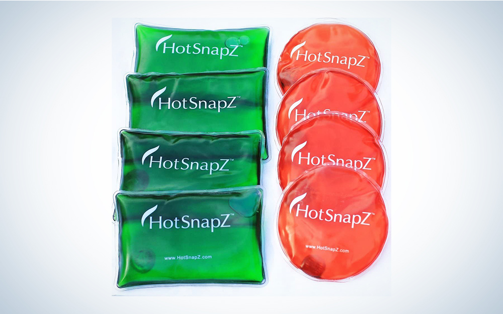 Red and green HotSnapZ Reusable Hand Warmers on a plain background