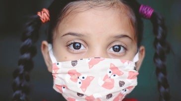 young girl wearing covid-19 mask
