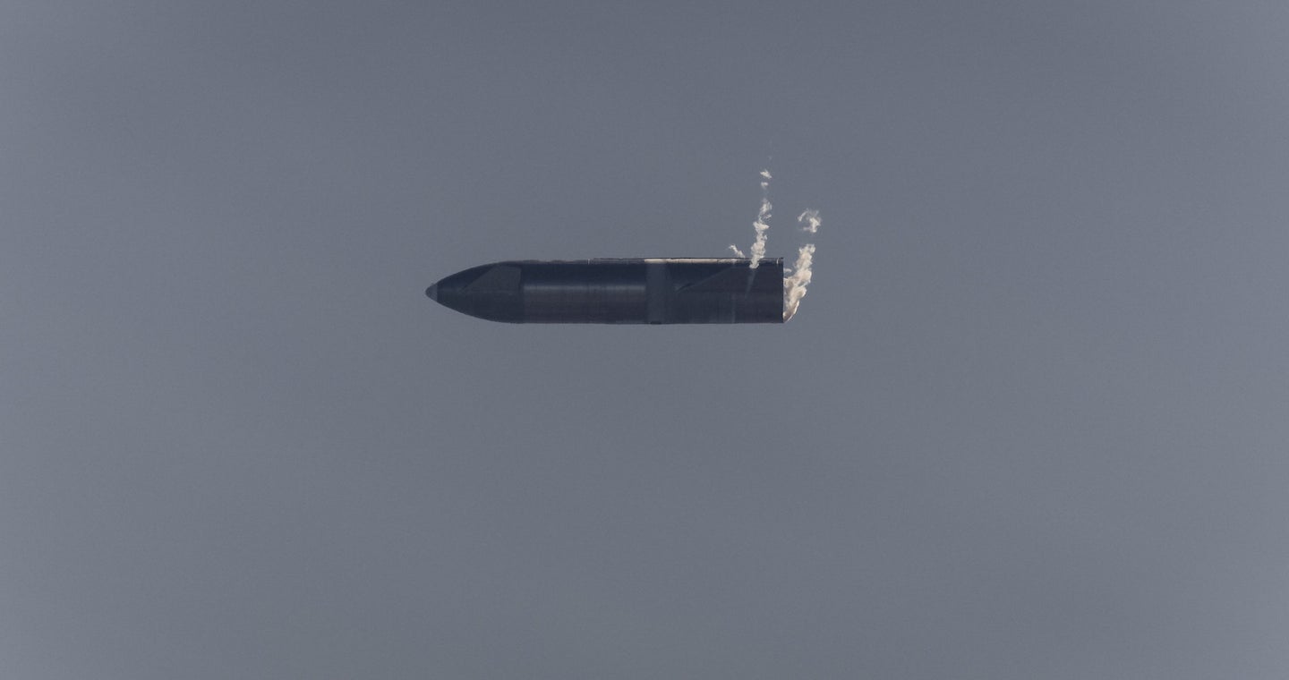 A SpaceX Starship rocket falls through the air horizontally during a test.