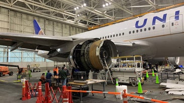 Boeing's damaged 777-200 parked in a hanger following an incident with its engine on Flight 328 on February 20.