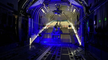 A drone in a launcher in the back of a cargo aircraft.