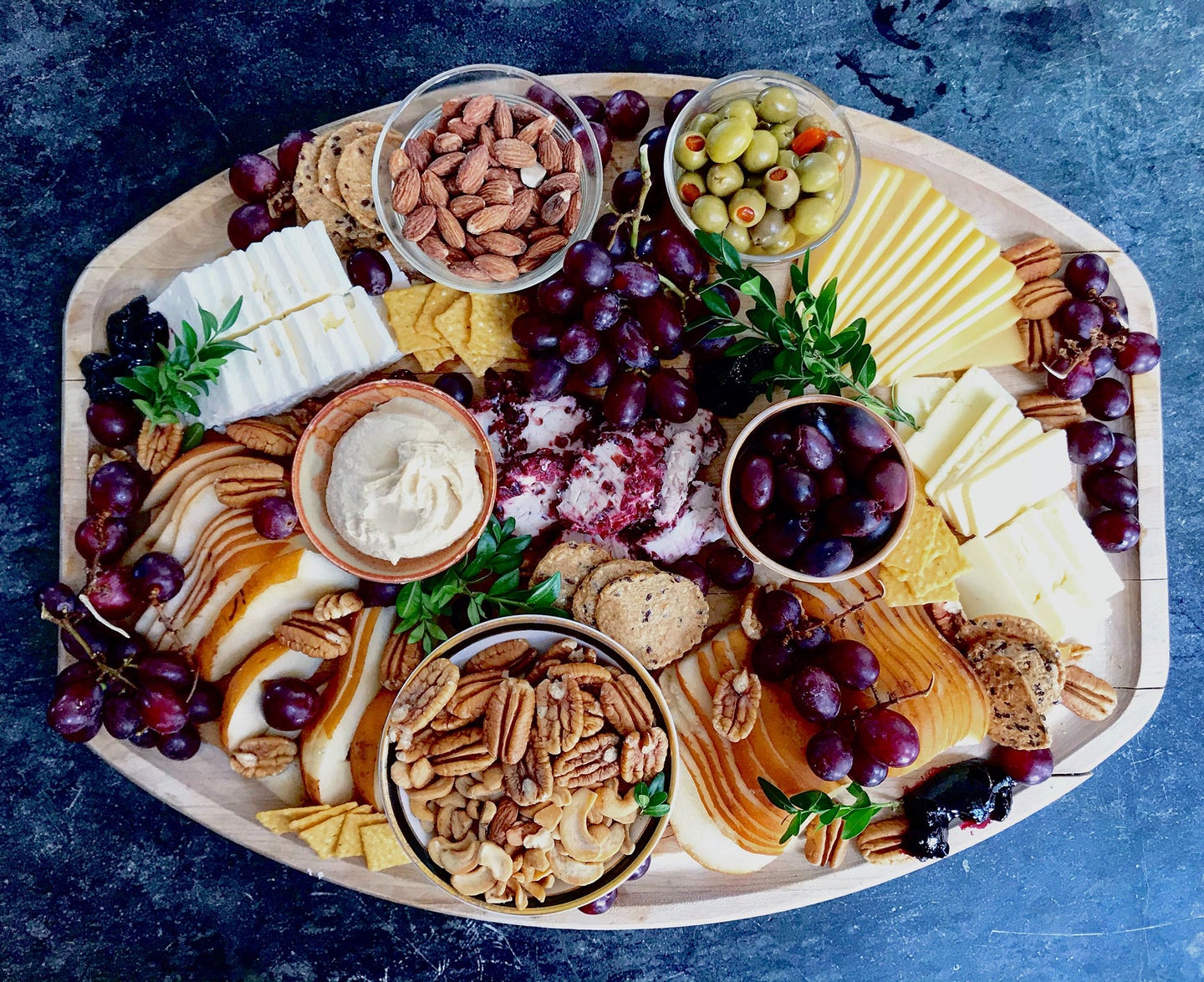 food platter with meats, cheeses, and fruits