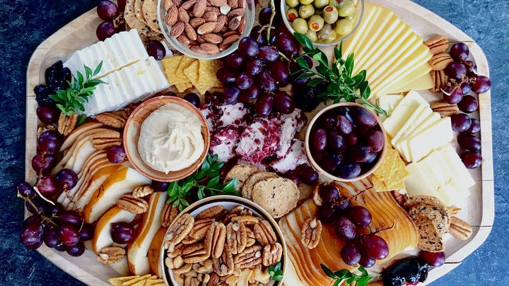 food platter with meats, cheeses, and fruits