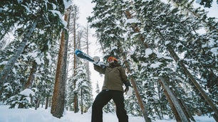 person in the best snow pants with skis on a mountain in front of trees