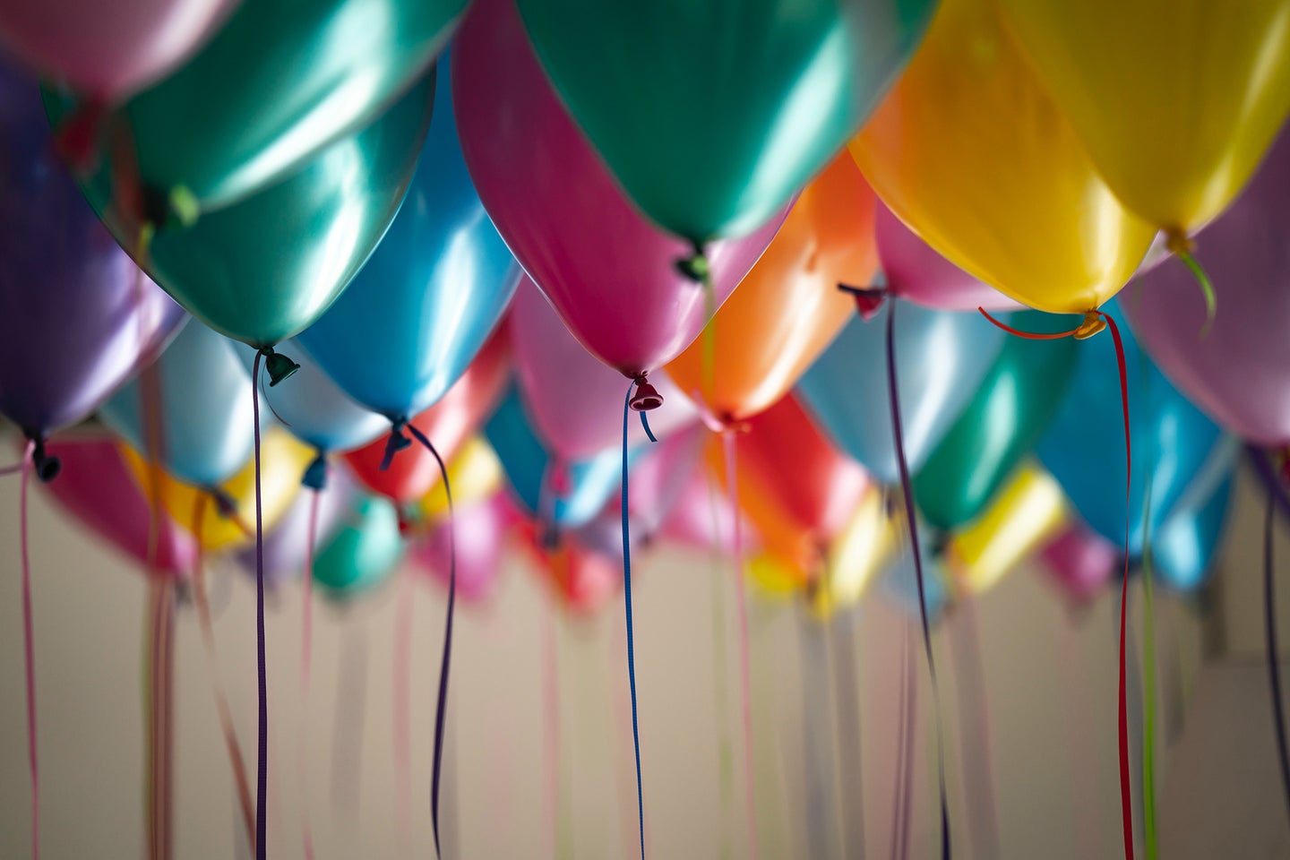 multiple colors of balloons with string hanging
