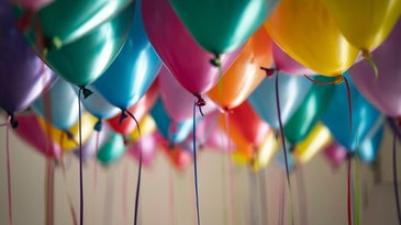 multiple colors of balloons with string hanging