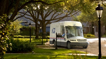 New USPS mail delivery truck in a simulated suburb