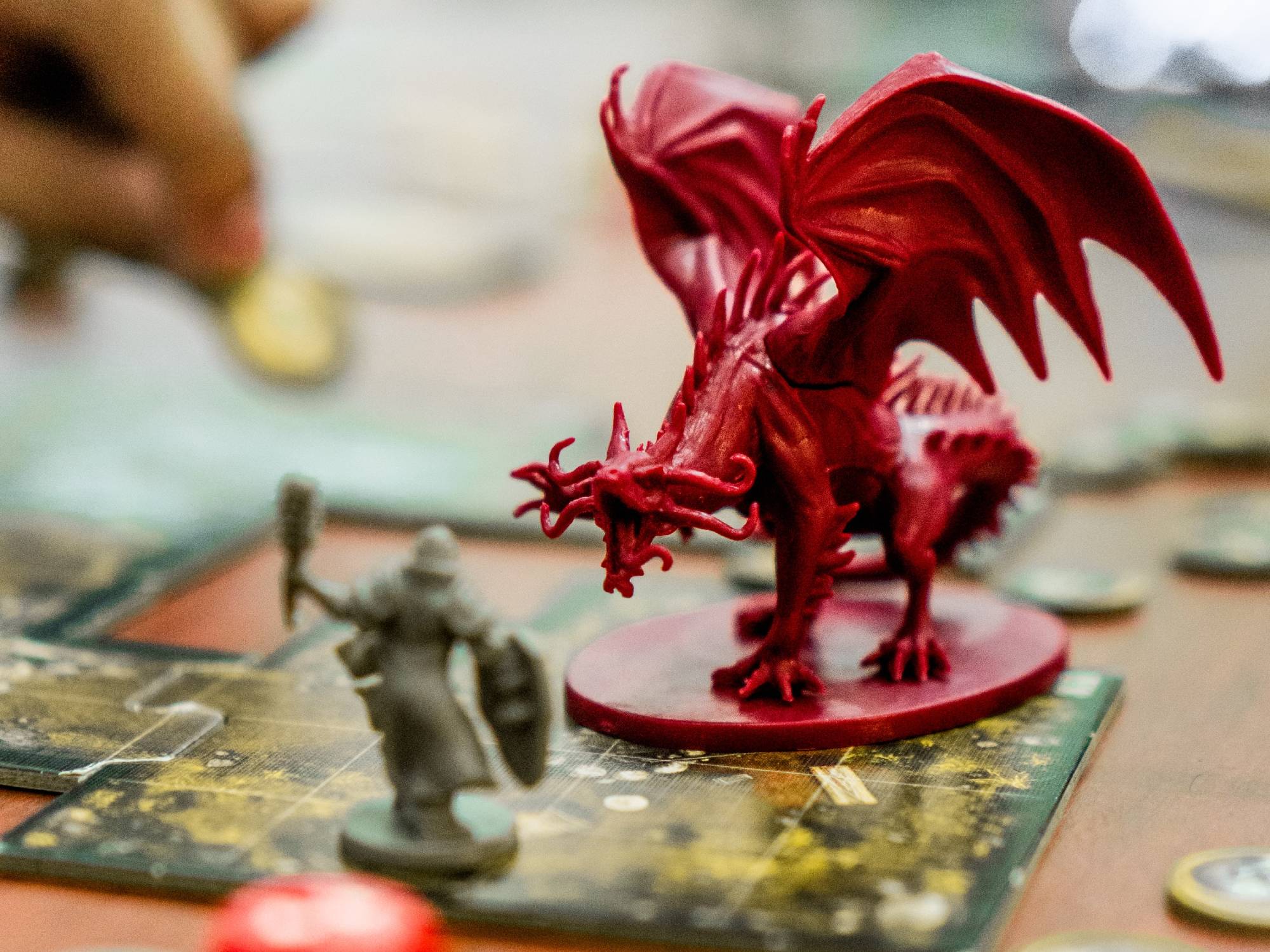 A plastic piece depicting a menacing plastic dragon on a board game