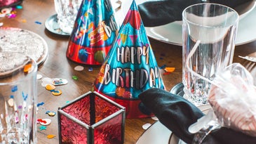 table with birthday hats and other festive items