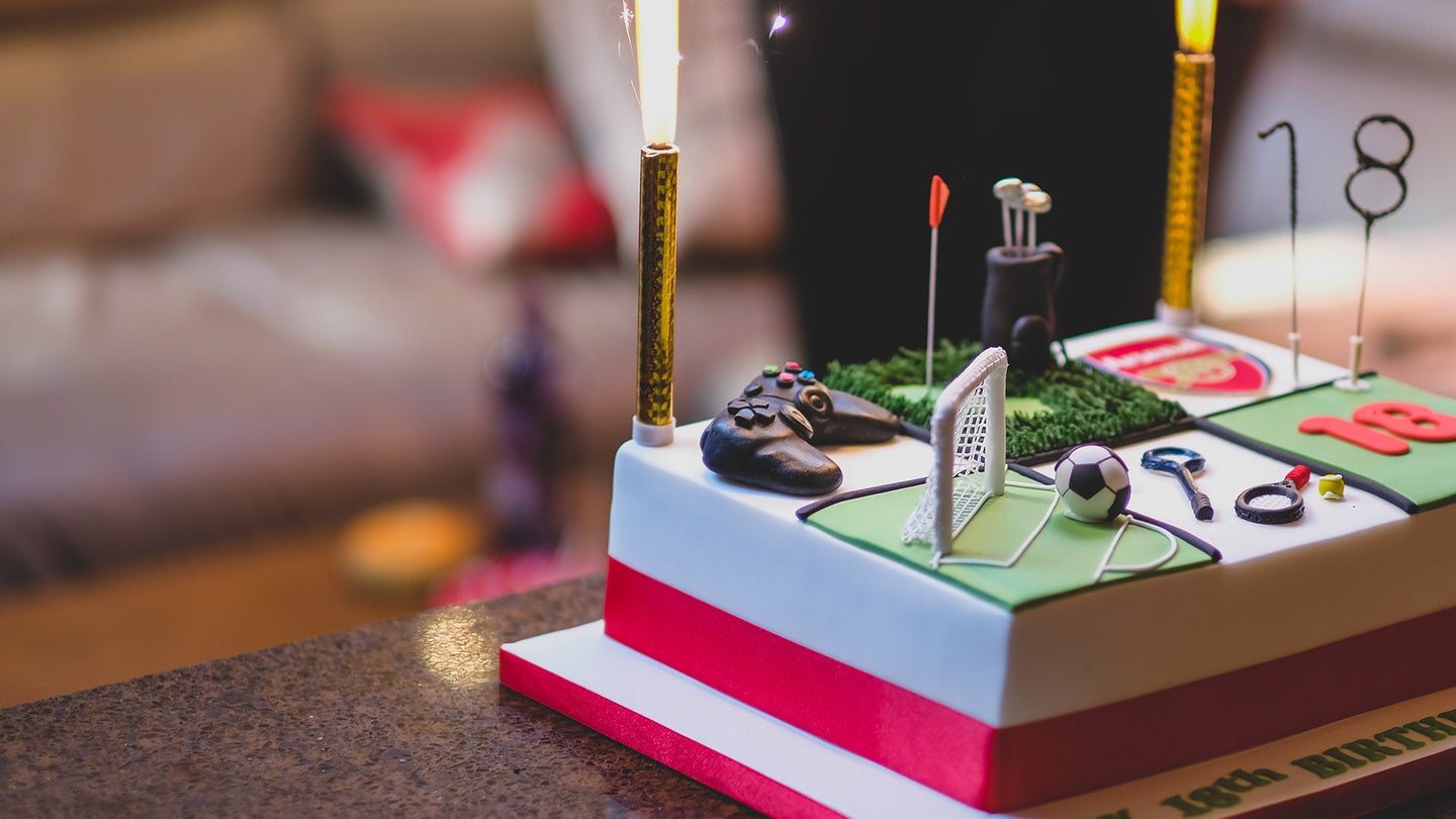rectangular 18th birthday cake with sparklers and games on it