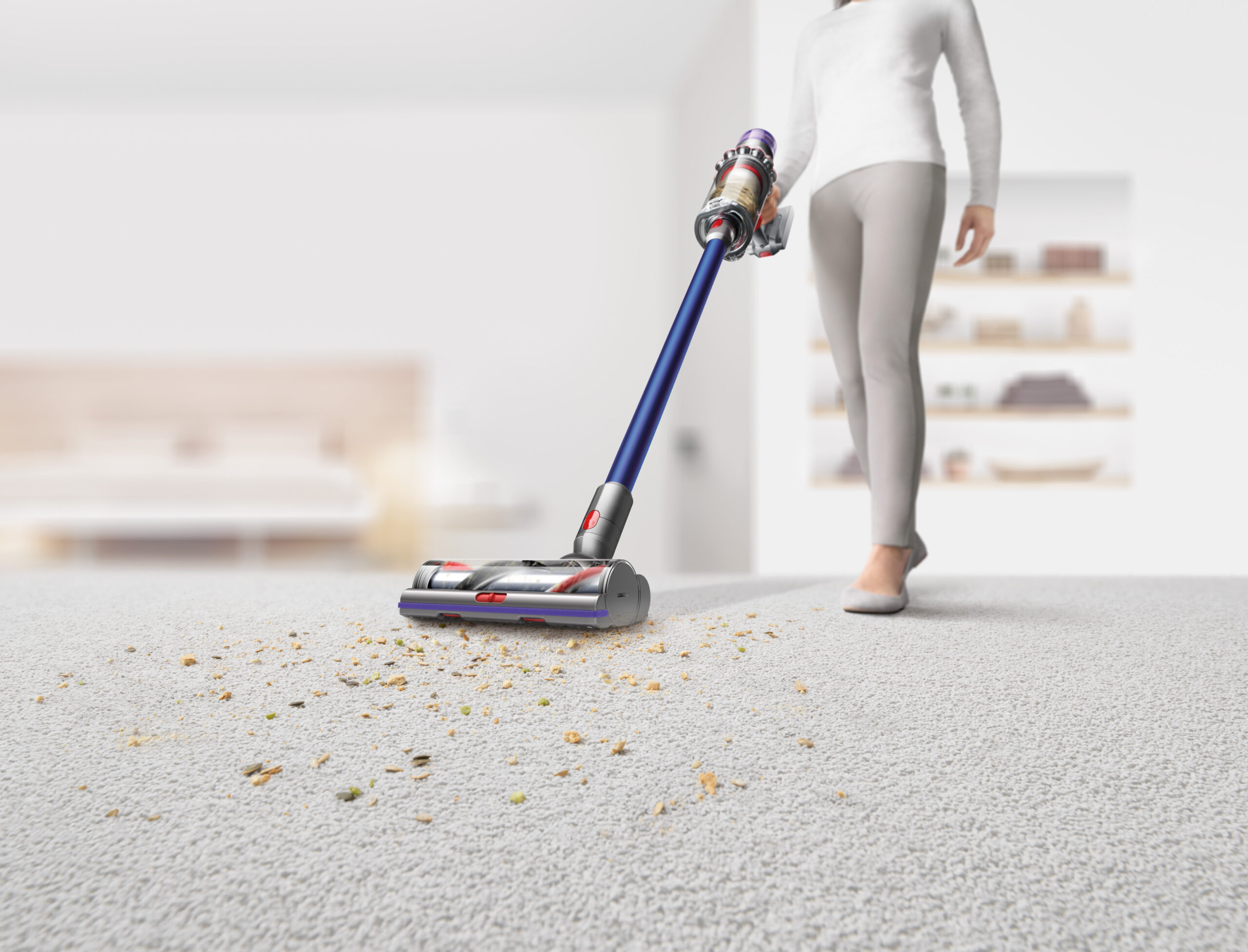 Person using the best dyson vacuum to clean up crumbs on a white rug