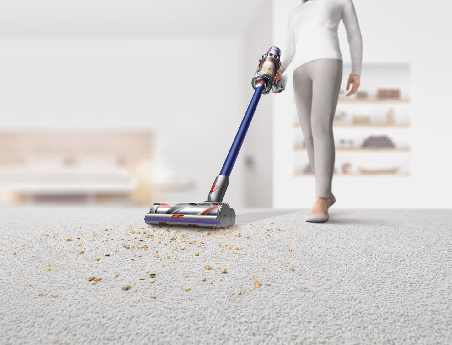 Person using the best dyson vacuum to clean up crumbs on a white rug