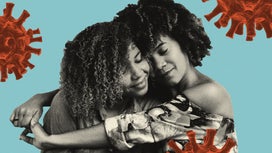 Two Black women with curly hair hug against a blue background featuring red coronavirus illustrations