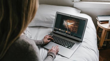 Person using a laptop in bed