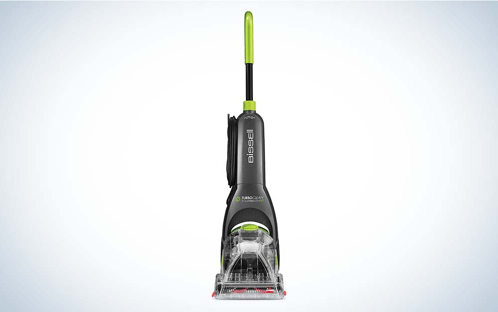The upright Bissell Turboclean Powerbrush Carpet Cleaner machine, which is black and gray with a green handle, against a plain background.