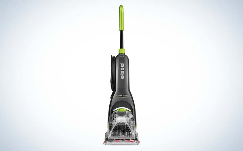 The upright Bissell Turboclean Powerbrush Carpet Cleaner machine, which is black and gray with a green handle, against a plain background.