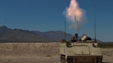 A 120mm mortar fires from a military vehicle.