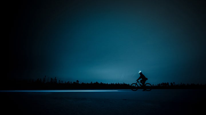 person on a bike with a headlamp