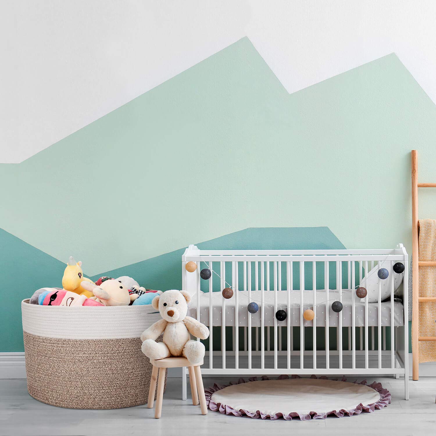 kid's room with a crib, toy basket, and other decorations