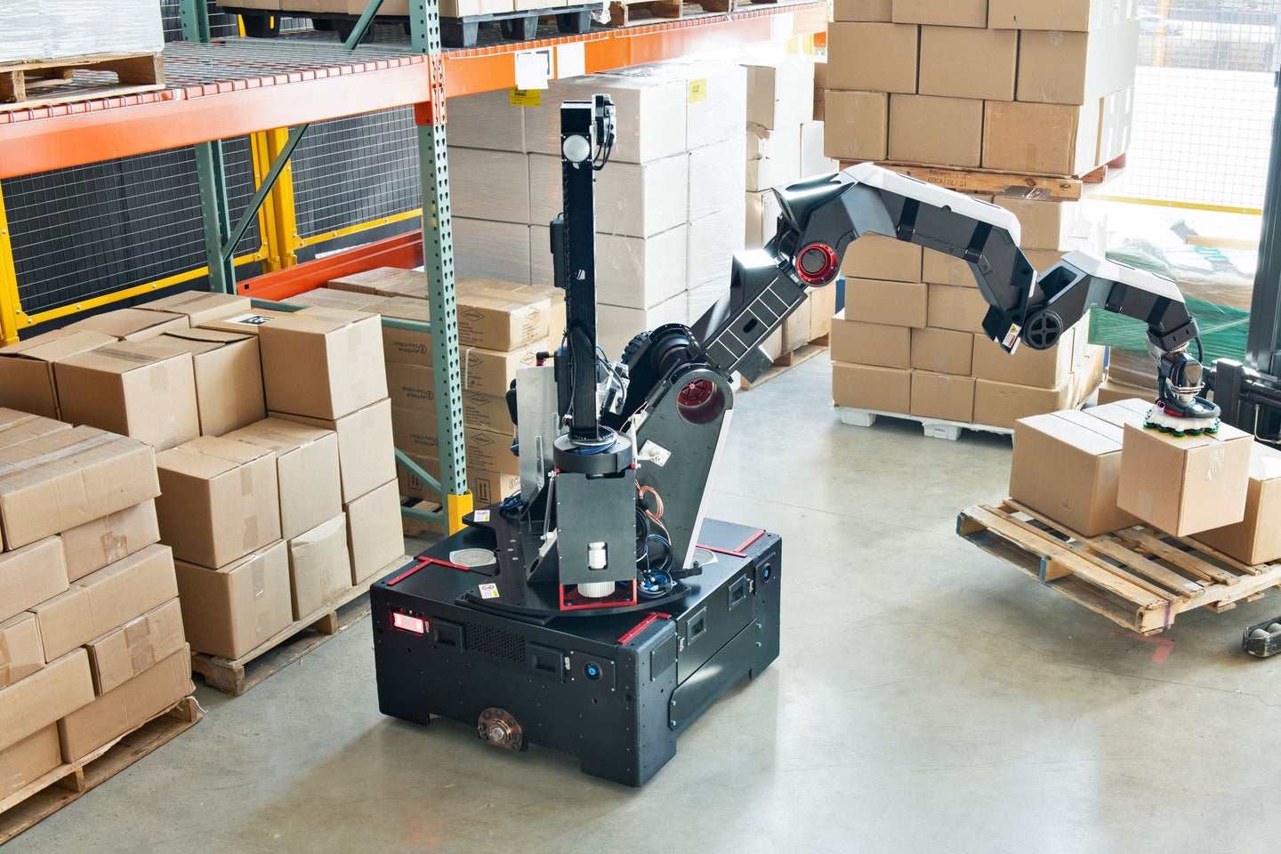 Boston Dynamics Stretch robot picking up boxes