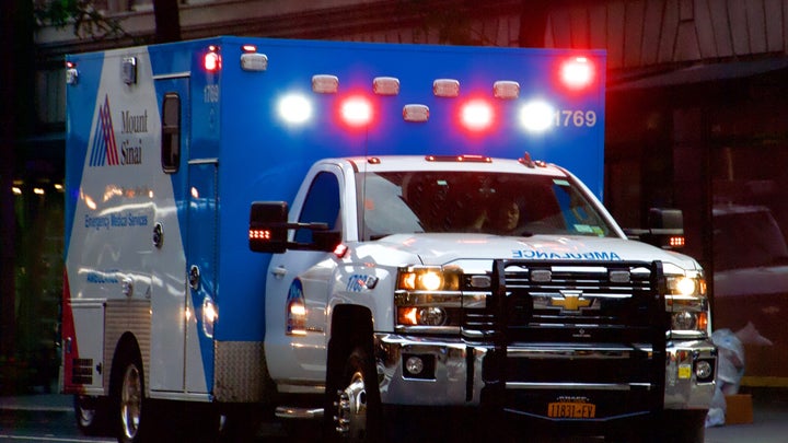 A Mount Sinai ambulance with its lights on in New York City.