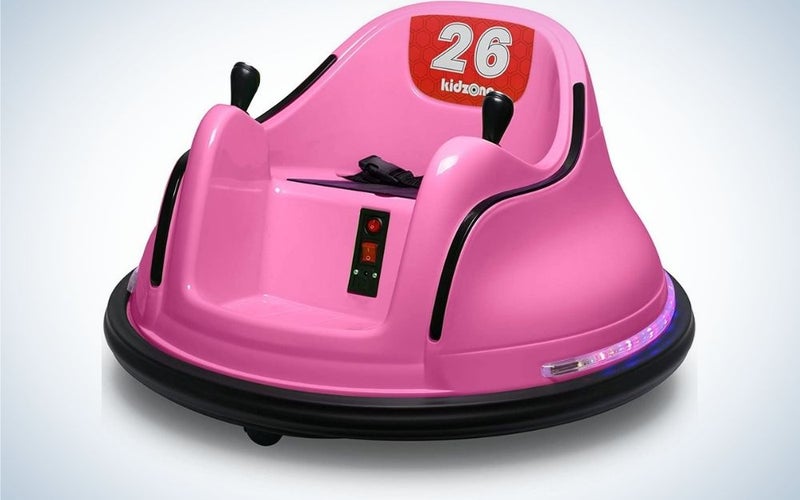 Kidzone pink electric rider toy with black safety belt and red buttons in front of it.