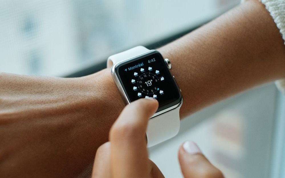 A white apple watch with a silver case