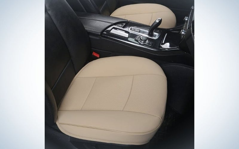 Inside a black car with a beige cover in the passenger and driver seats.