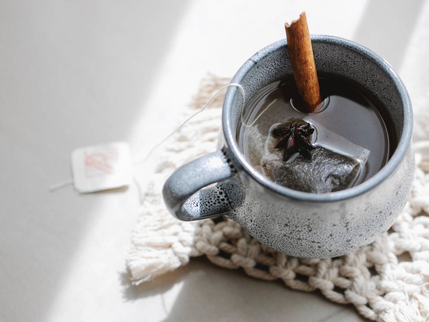 A cup of tea with a cinnamon stick in it