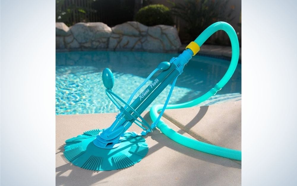 A sky color extreme power vacuum cleaner with a pool at the back.