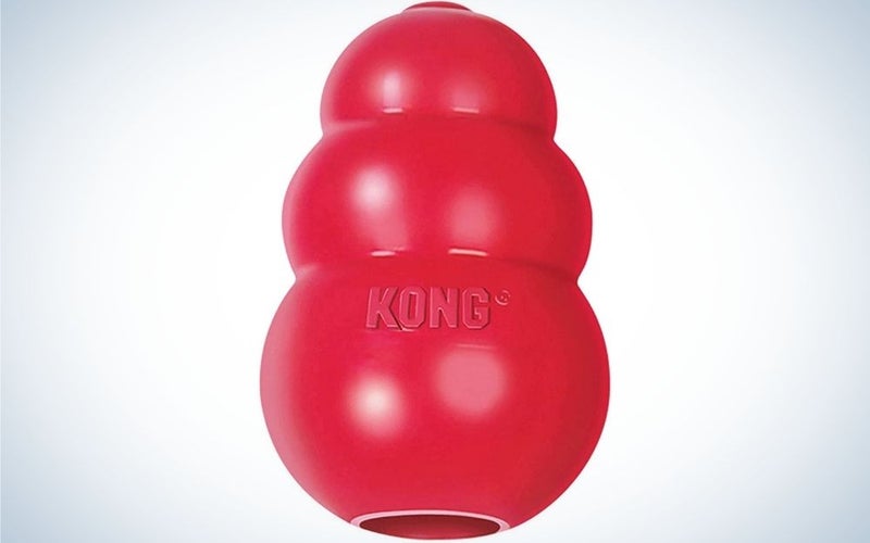 A red classic dog toy looking like three balls of different sizes in one.