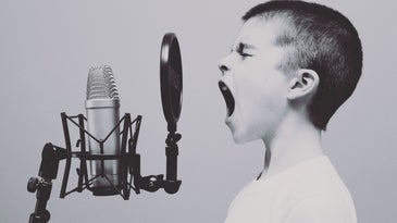 boy screaming into microphone