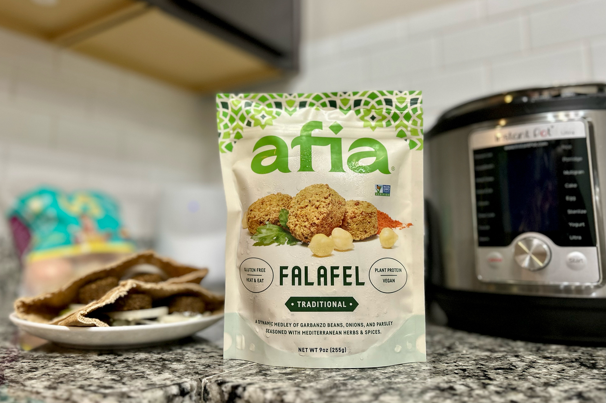Afia Falafel packaging on the counter between a pita and an air fryer