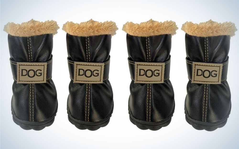 Four black pair of dog boots with beige fur on top of them and dog lettering with capitals in middle of each boot.