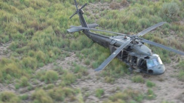 Black Hawk helicopter in field.