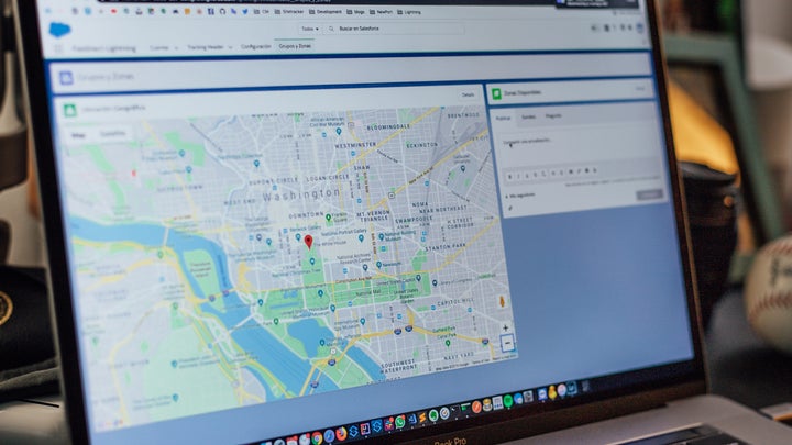 A laptop open with an image of Google Maps on the screen.