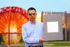 Xiulin Ruan, a Purdue University professor of mechanical engineering, holds up his lab’s sample of the whitest paint on record. (Purdue University/Jared Pike)
