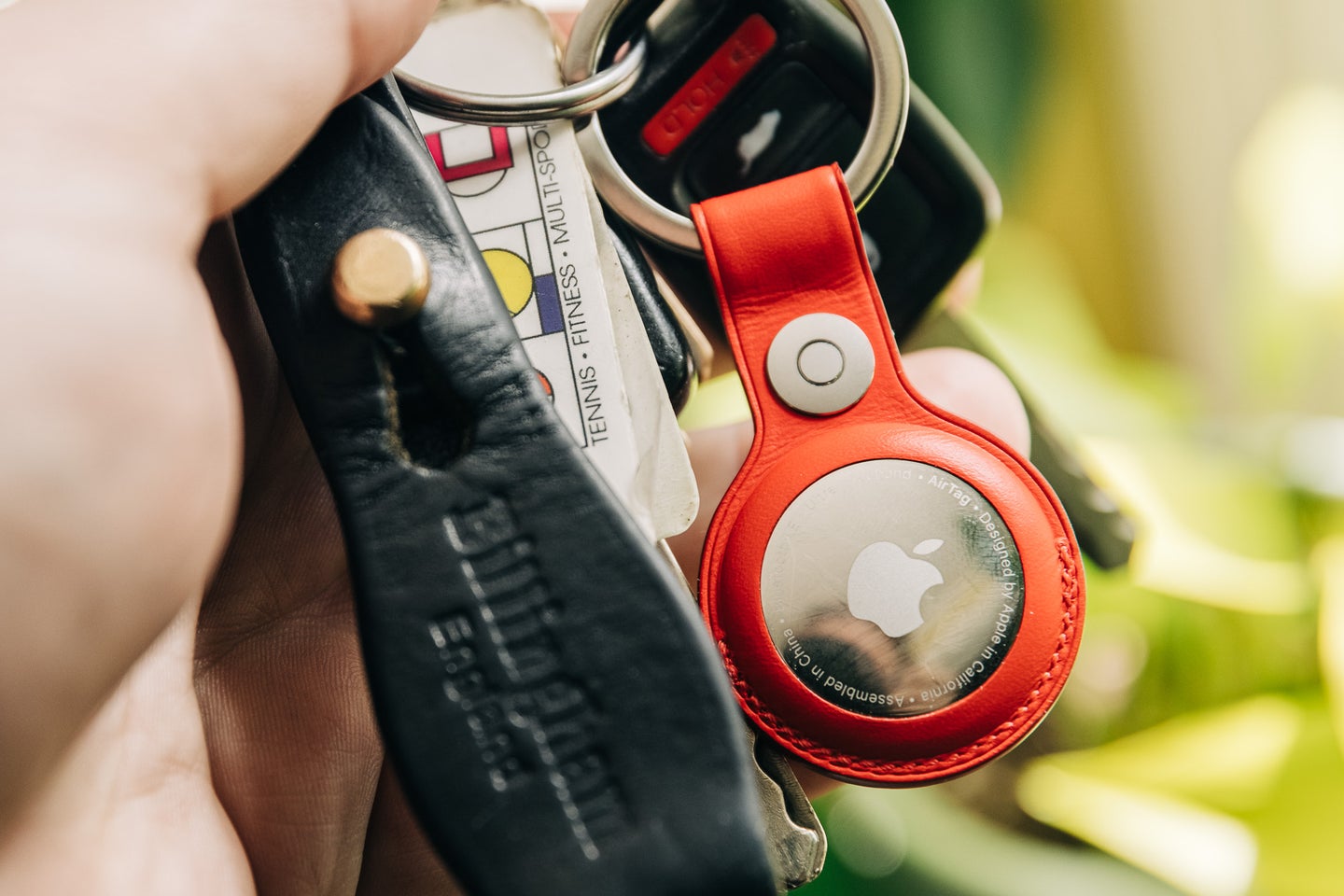 Apple AirTag on keys with the red leather key ring